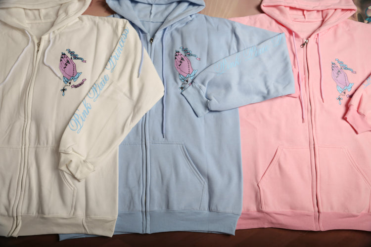 Prayer hands hoodie set: cream, light blue, and pink, each with front prayer-hands graphic