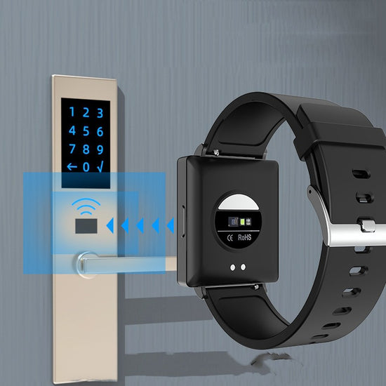 Black smartwatch with back sensor area and charging contacts, black silicone strap