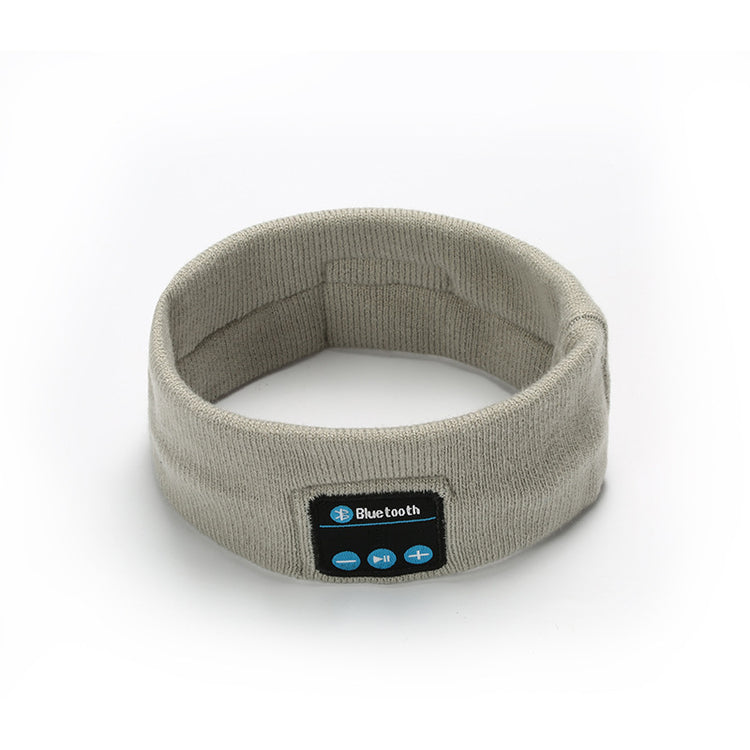 Light gray Bluetooth headband with front control panel and button icons