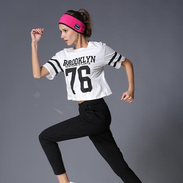 Pink Bluetooth fitness headband worn by model during activity