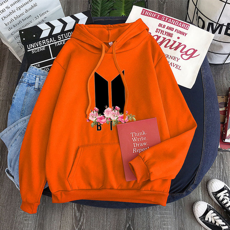 Orange youth hoodie with heart-flower garland graphic, drawstring hood and kangaroo pocket
