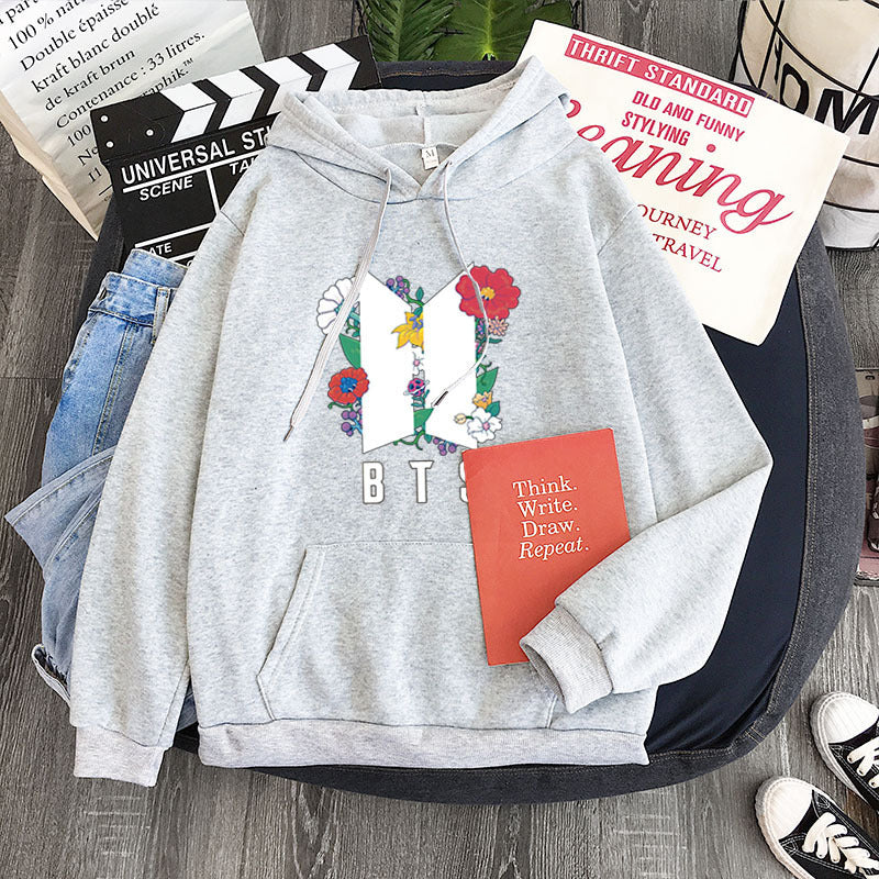 Light gray youth pullover hoodie with flower heart front graphic and B T S print