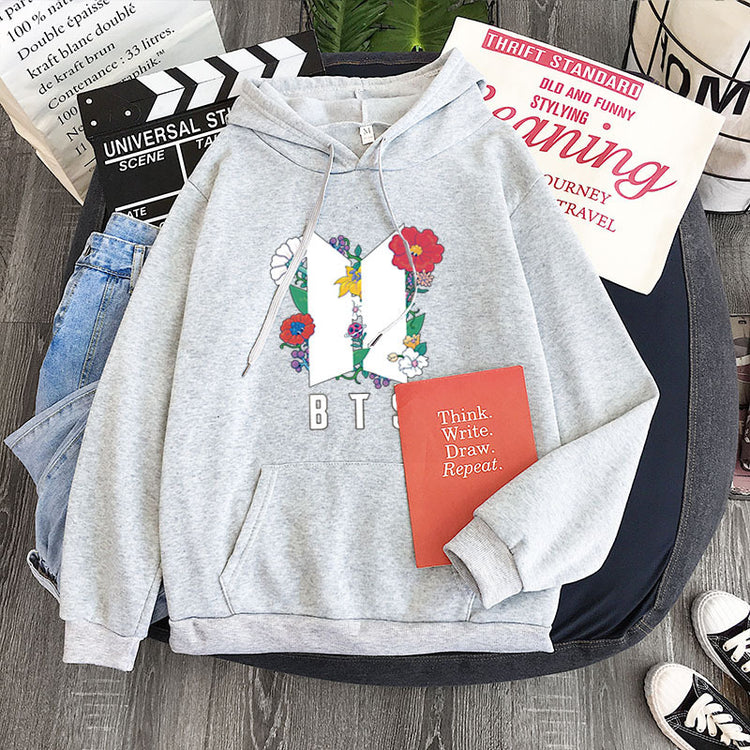 Light gray youth pullover hoodie with flower heart front graphic and B T S print