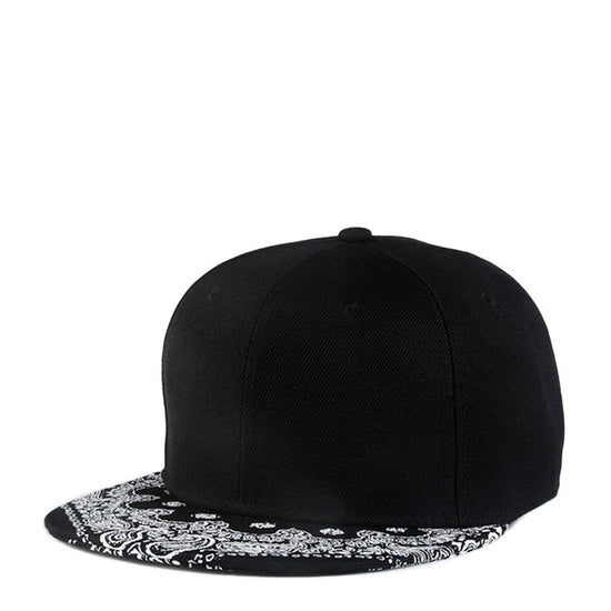 Black baseball cap with white paisley print flat brim and button top