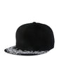 Black baseball cap with white paisley print flat brim and button top