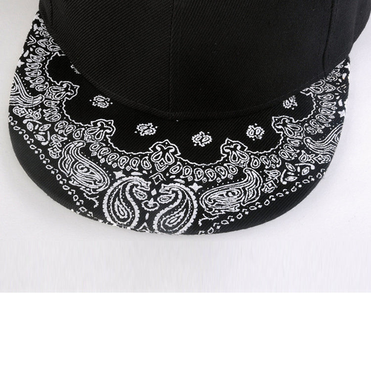 Paisley print brim on black baseball cap, close-up of white motifs