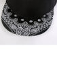 Paisley print brim on black baseball cap, close-up of white motifs
