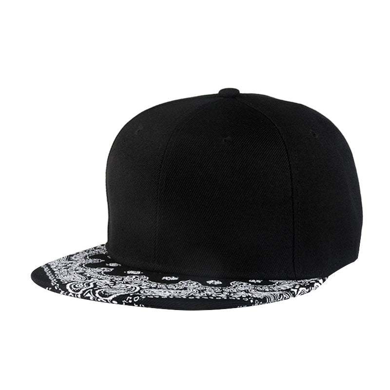 Black baseball cap with white paisley print brim and rounded crown
