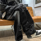 Black denim wide-leg pants with star patches and distressed knee rips