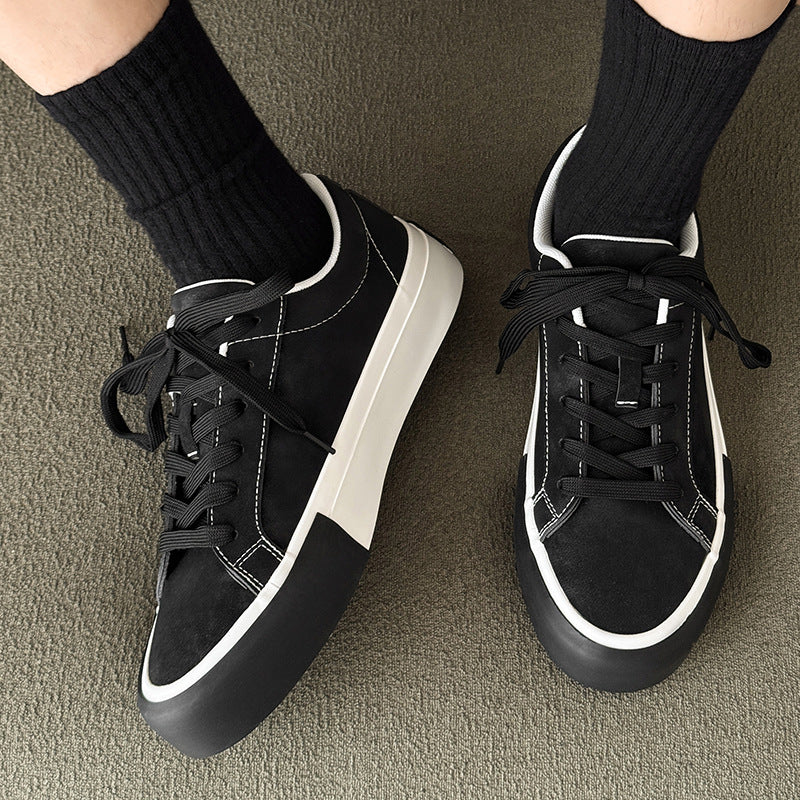 Black low-top sneakers with lace-up closures and white trim, side-by-side view