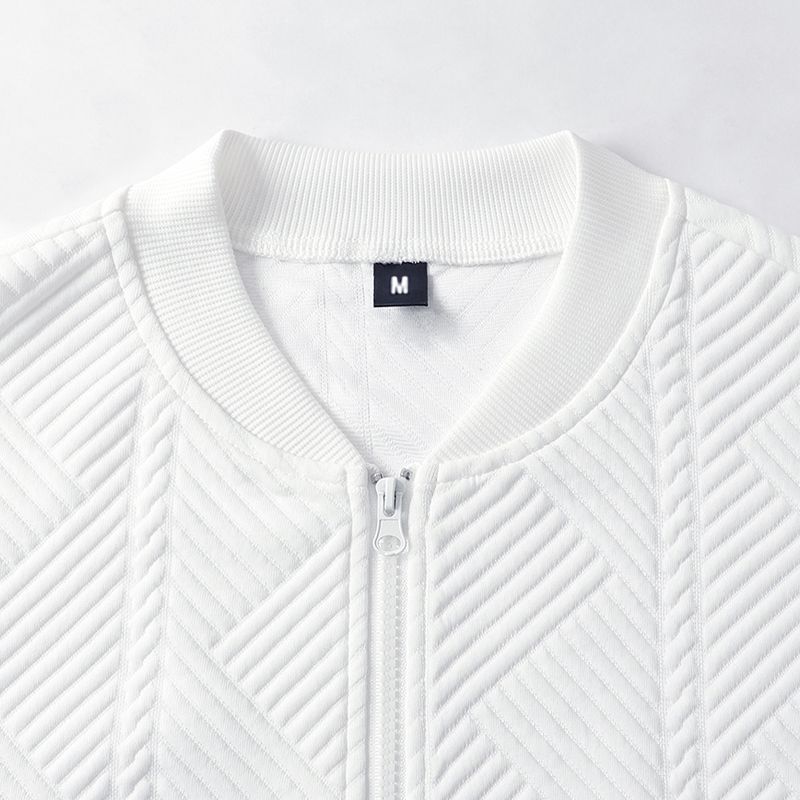 White textured zip-front coat close-up, stand collar and zipper pull