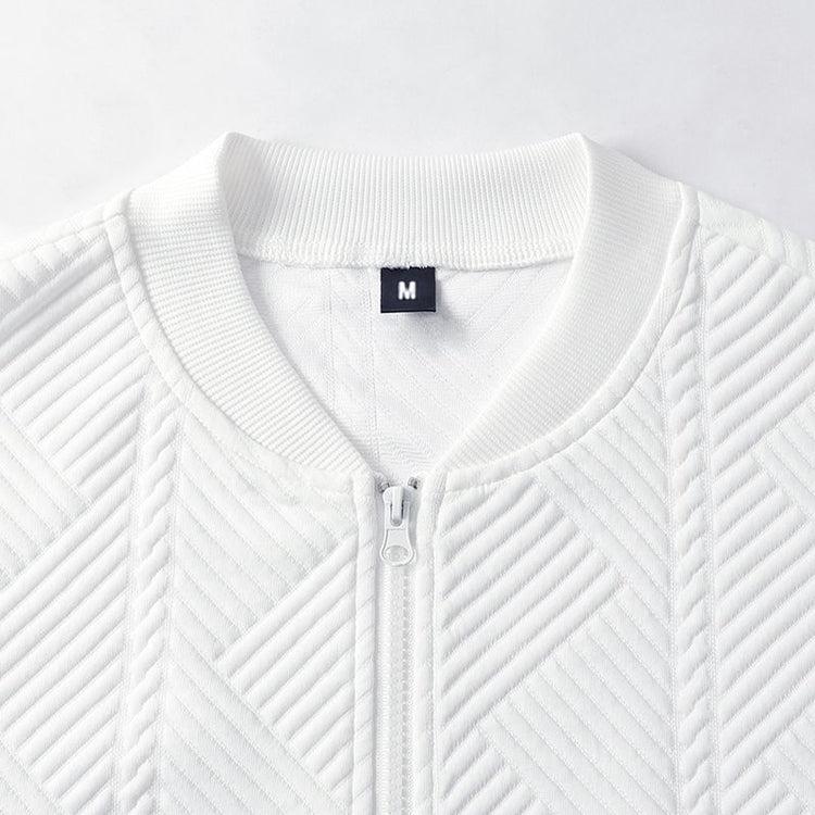 White textured zip-front coat close-up, stand collar and zipper pull