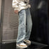Light blue denim pants with star appliques along outer seams and frayed cuffs