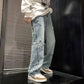 Light blue denim pants with star appliques along outer seams and frayed cuffs