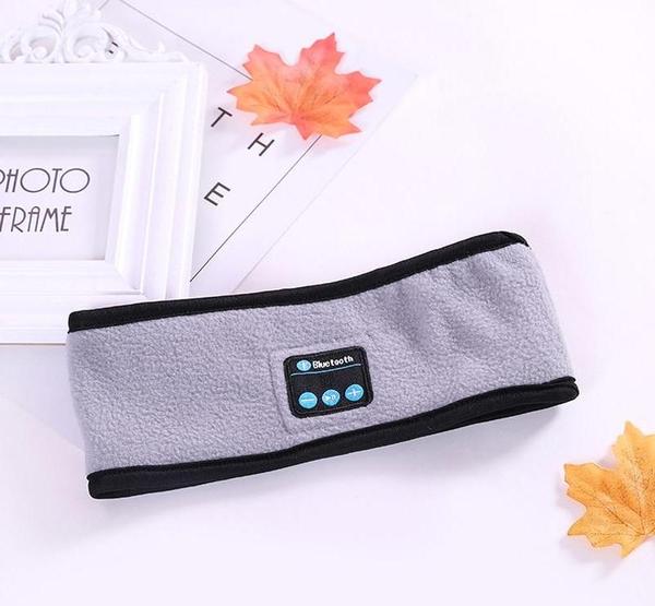 Light gray Bluetooth headband with black trim and front control panel