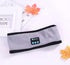 Light gray Bluetooth headband with black trim and front control panel