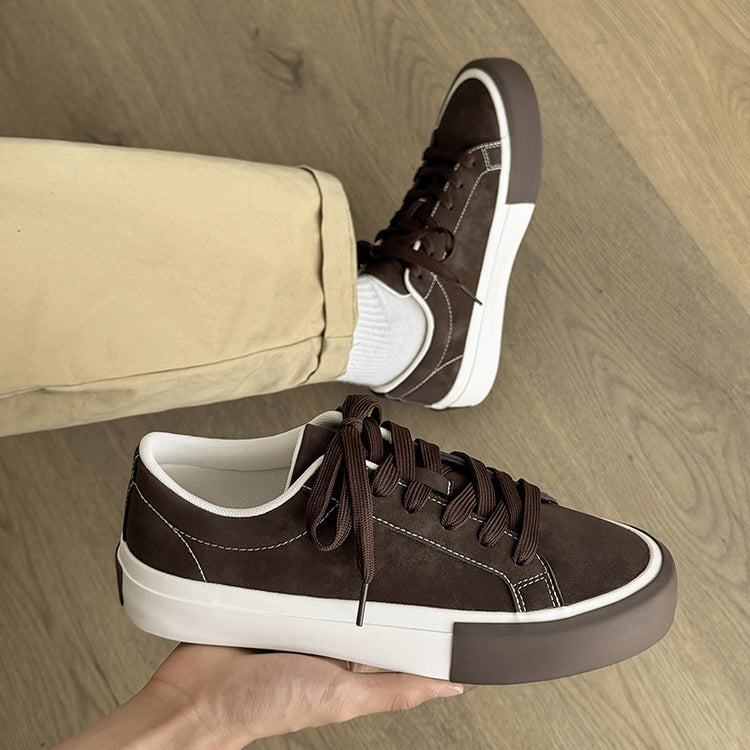 Khaki-brown low-top sneakers with lace-up front, white sole, and contrast stitching