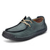 Teal green lace-up casual shoes with cream laces, black trim, stitched upper.
