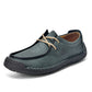 Teal green lace-up casual shoes with cream laces, black trim, stitched upper.