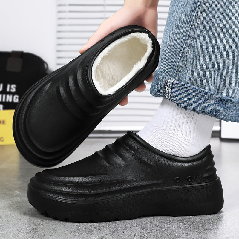 Black chef clogs on foot, showing fleece-lined opening and thick platform tread
