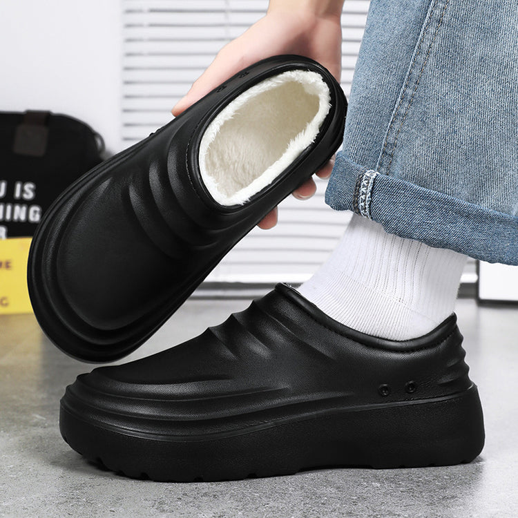 Black chef clogs on foot, showing fleece-lined opening and thick platform tread