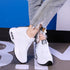 White knit lace-up sneakers with black trim and white air-cushion platform sole