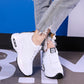 White knit lace-up sneakers with black trim and white air-cushion platform sole