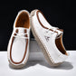 White lace-up casual shoes with brown trim and lace, stitched moccasin-style upper.