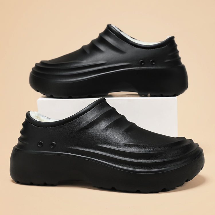 Black chef clog shoes with ridged upper, fleece collar lining, and chunky tread sole