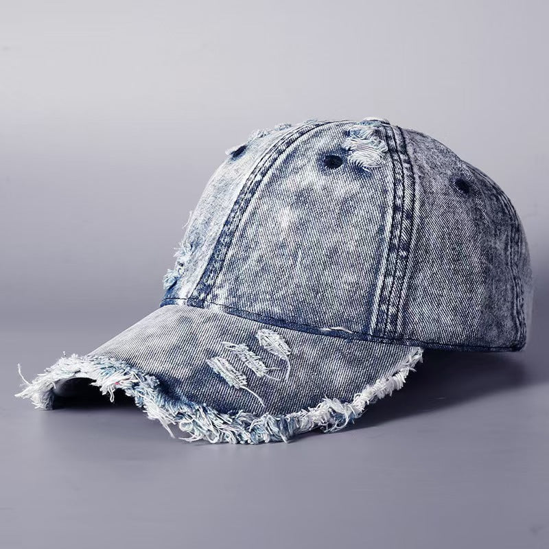 Washed denim baseball cap with frayed brim and distressed side panel, light wash denim.