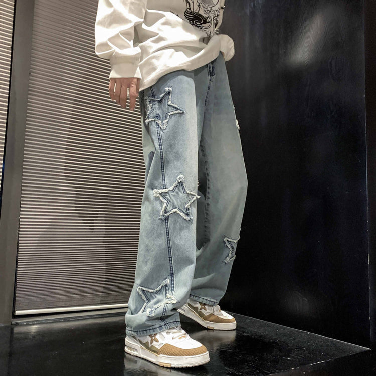 Light blue denim straight-leg pants with star-shaped distressed patches