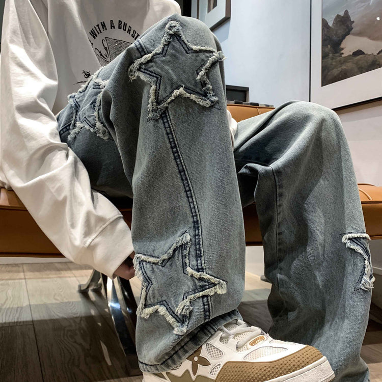 Light blue wide-leg denim pants with star appliques on side panels