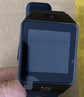 Smart watch close-up with dark screen, black case and blue-backed strap