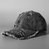 Washed denim baseball cap with distressed crown and frayed brim, dark wash.