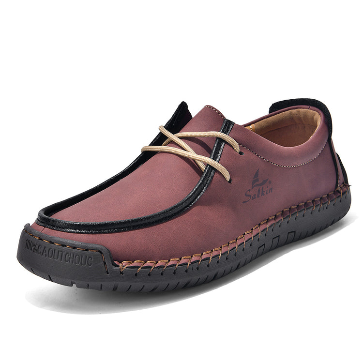 Burgundy lace-up casual shoes with cream laces and black trim, stitched upper.