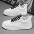 White sneakers with black lace-up details and chunky textured sole