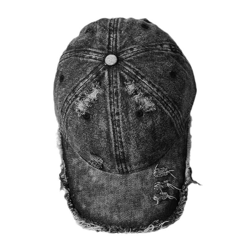 Washed denim baseball cap with distressed stitching and frayed brim, dark wash.
