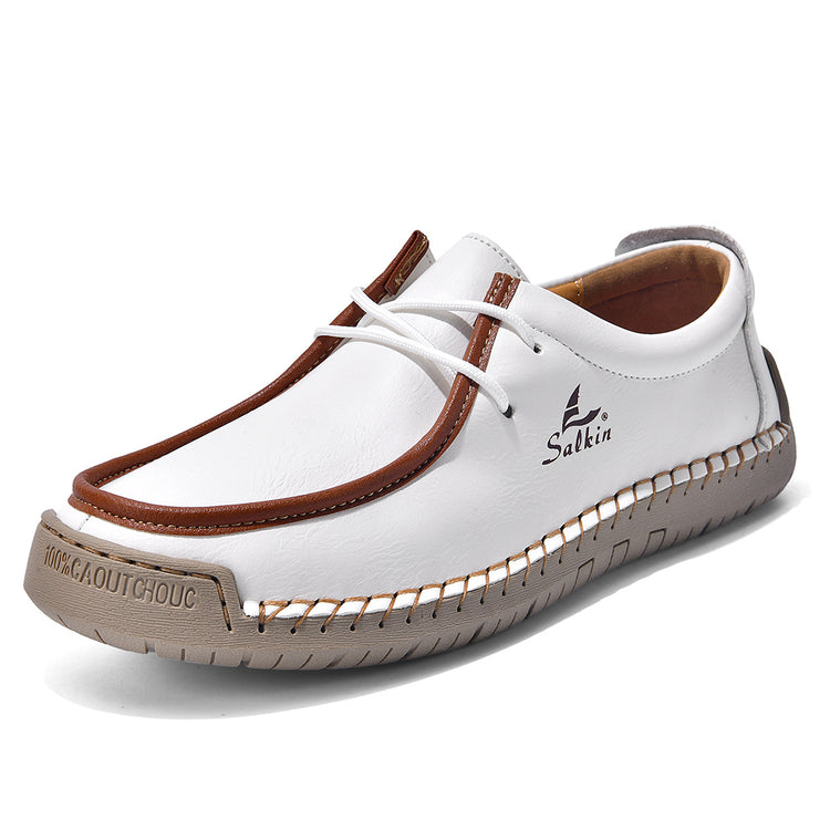 White lace-up casual shoes with brown trim and white laces, stitched moccasin-style upper.