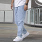 Light blue slim jeans showing side seam and tapered fit at ankle