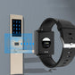 Black smartwatch with back sensor area and charging contacts, black silicone strap