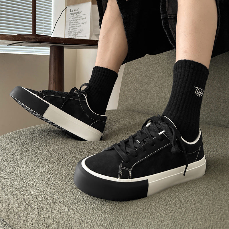 Black low-top sneakers with lace-up, white sole, and thick platform heel