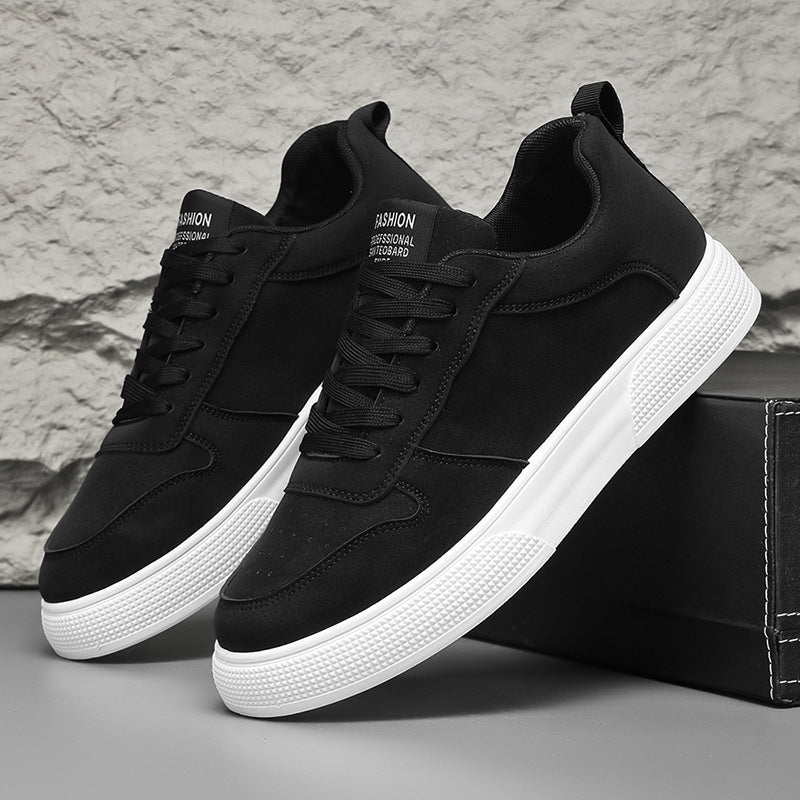 Black sneakers with white textured sole and black lace-up closure