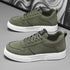 Olive green sneakers with white sole and lace-up closure
