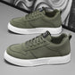 Olive green sneakers with white sole and lace-up closure