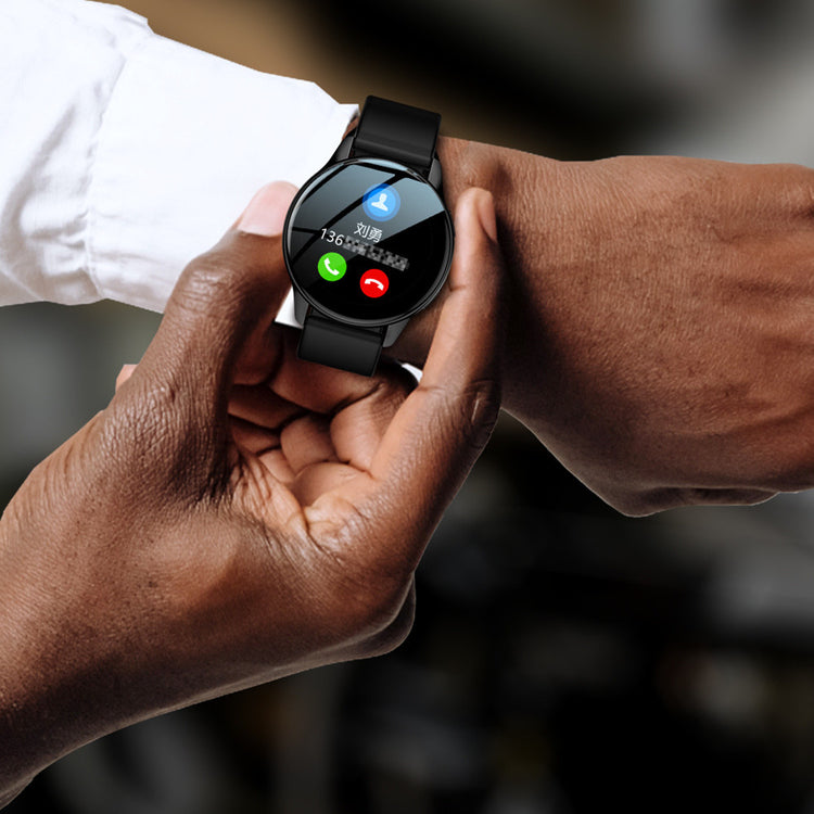 Smartwatch with black silicone strap, round black screen showing call icons and time.