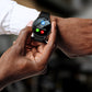 Smartwatch with black silicone strap, round black screen showing call icons and time.