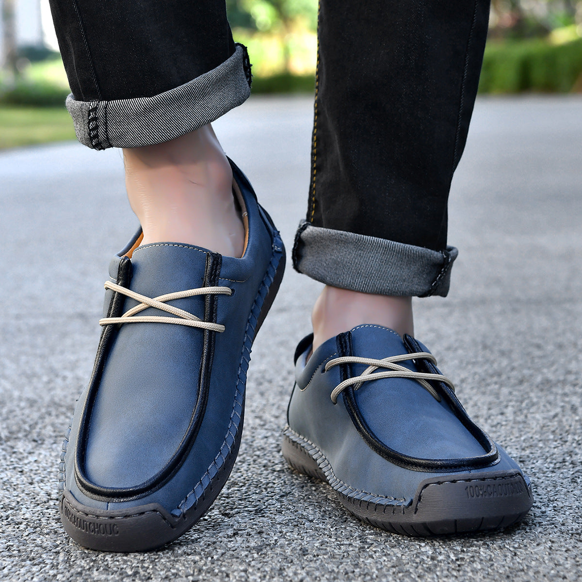 Dark blue lace-up casual shoes with cream laces and cushioned stitched upper.