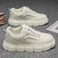 Off-white lace-up chunky-sole sneakers, front view, stitched side panels and perforations