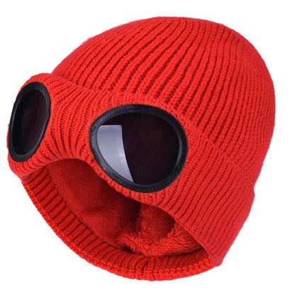 Red knitted beanie with windproof eye shields, close-up