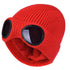 Red knitted beanie with windproof eye shields, close-up